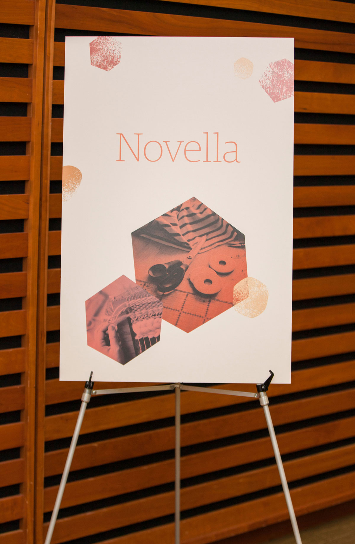 An easel with a poster with Etsy Captain's Summit branding. This room is named Novella