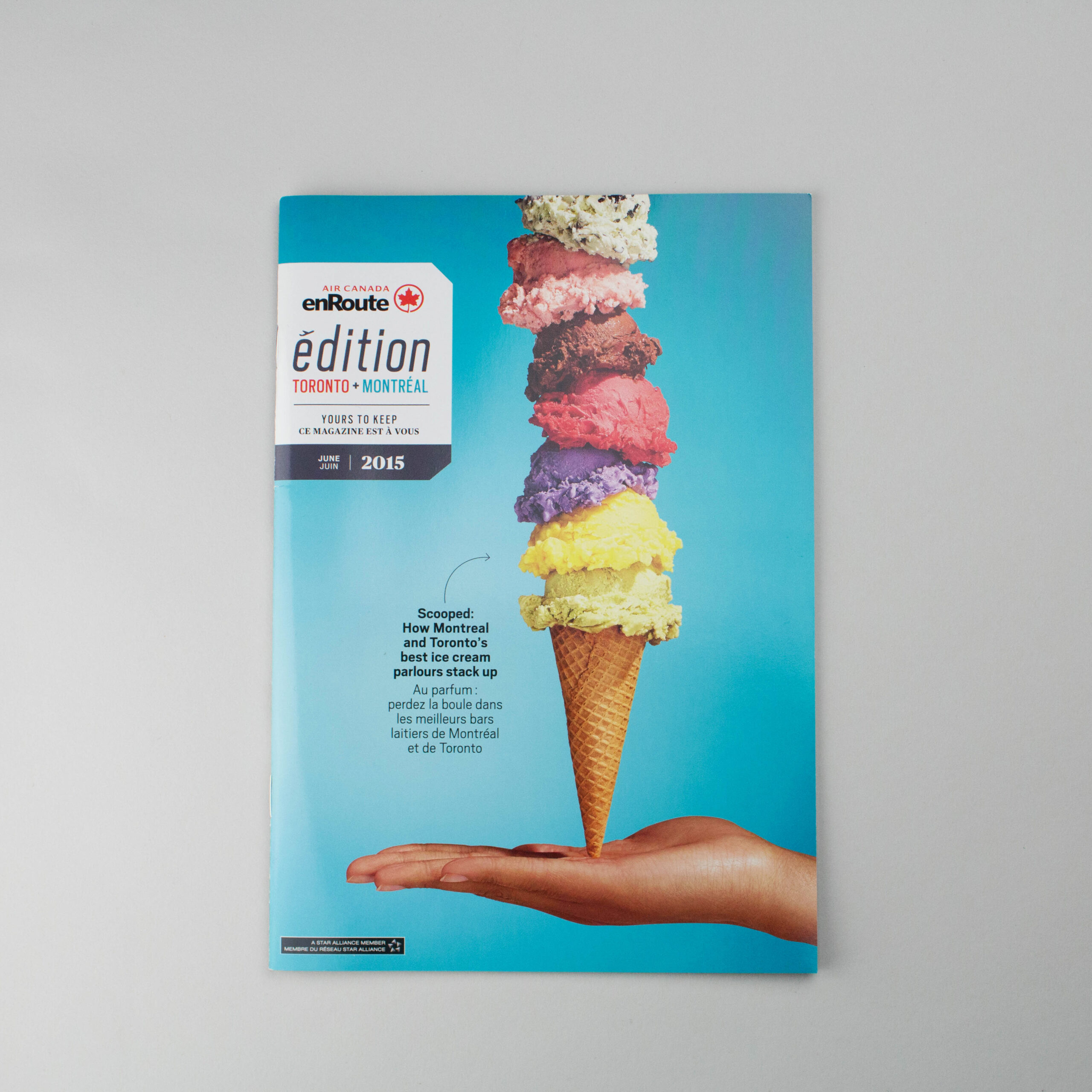 A whimsical stack of ice cream on a cone, hovering above a open hand. Art directed by Jen Spinner.