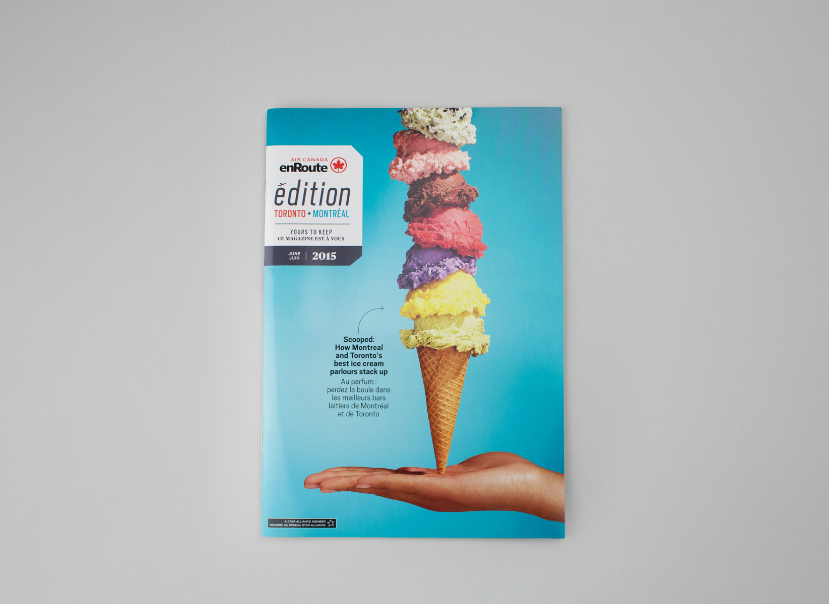 A whimsical stack of ice cream on a cone, hovering above a open hand. Art directed by Jen Spinner.