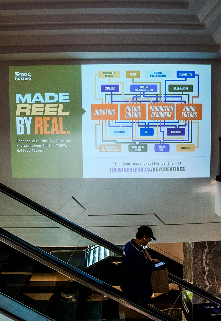 Etsy Market banner mock up image showing a person walking in an office with the Etsy banner on the wall. By Spinner Design.